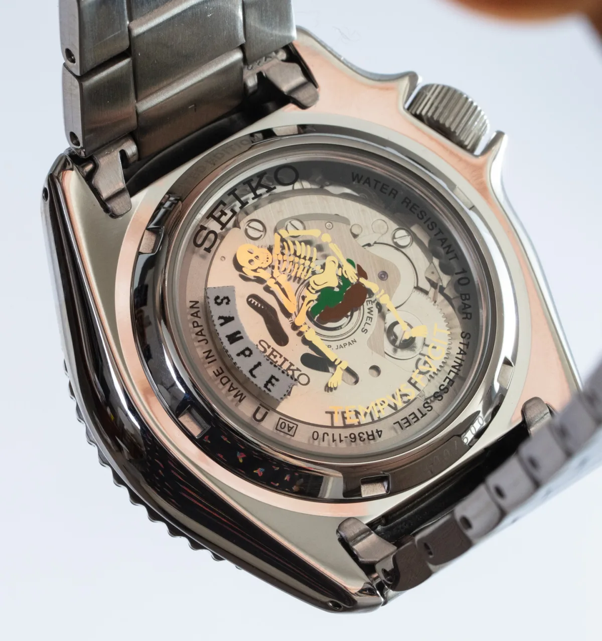 Display case back of Seiko 5 Sports x Rowing Blazers showing movement and skeleton motif.