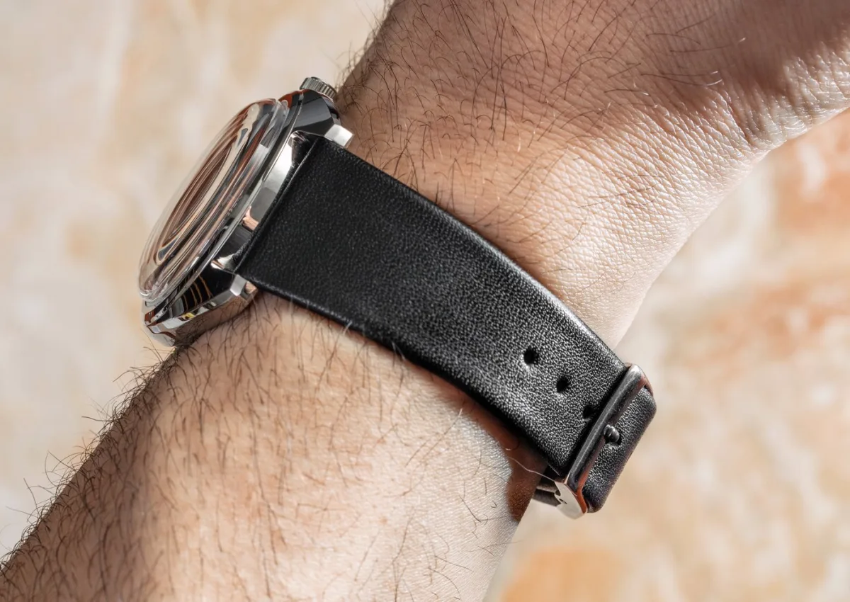 Close-up of the silver dial with vertical stripes