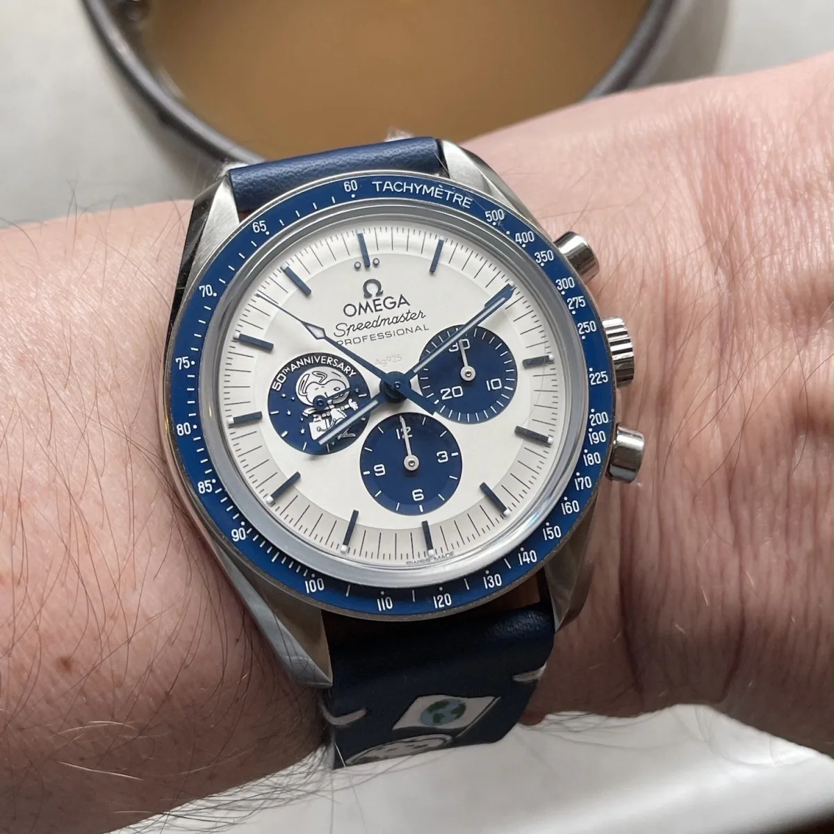 Omega Speedmaster Silver Snoopy Award on wrist