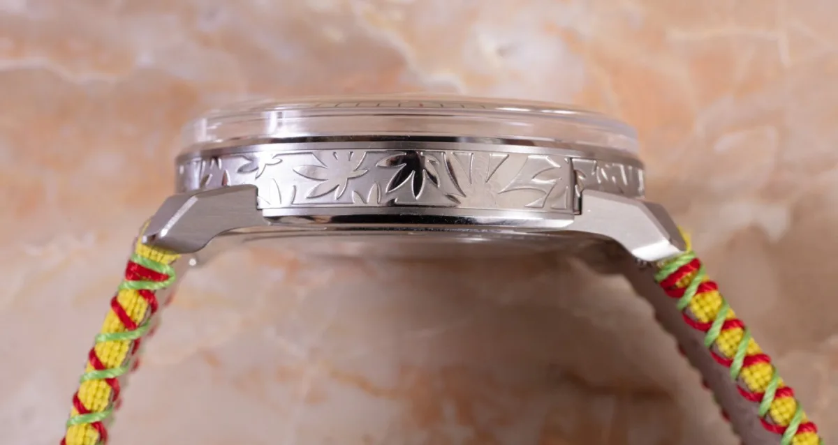 Close-up of hemp leaf engraving on watch case