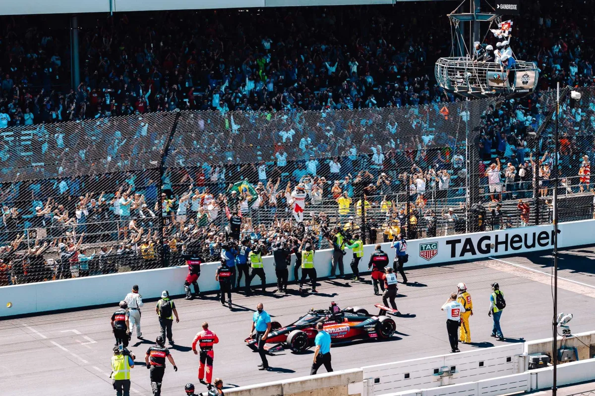 Helio Castroneves crossing the finish line
