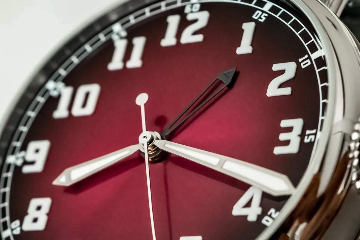 Close-up of the burgundy fumé dial