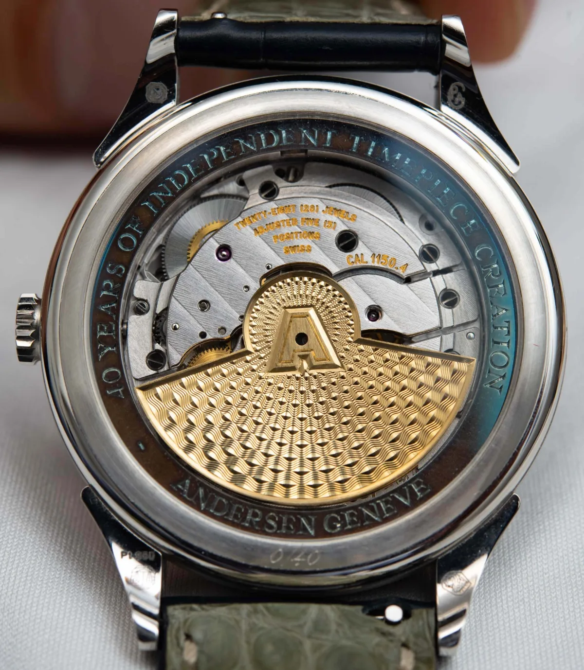 Andersen Geneve watch rotor with guilloché pattern.