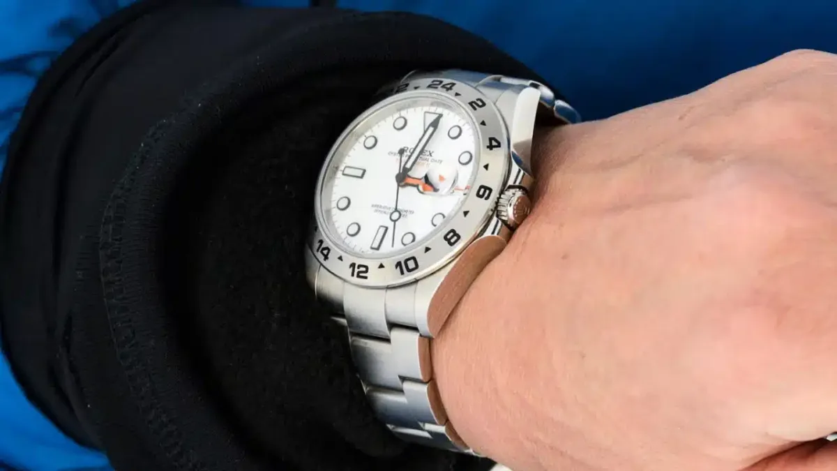 Rolex watch displayed prominently.