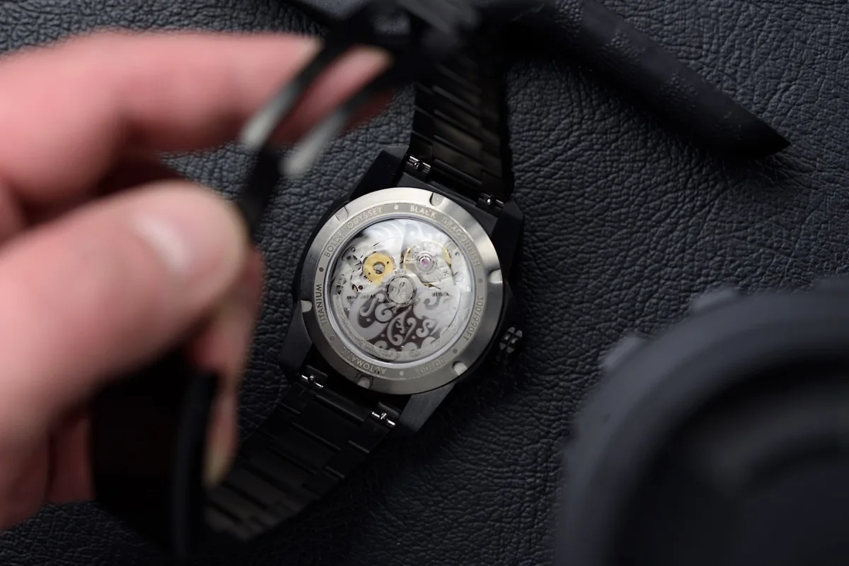 Luminous dial and bezel of the Odyssey Black Dragonfish glowing in the dark