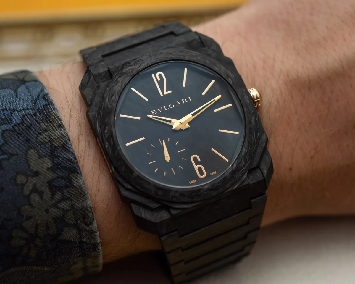Mechanical watch movement visible.