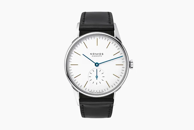 NOMOS Orion watch with white dial, blued steel hands, and gold hour markers