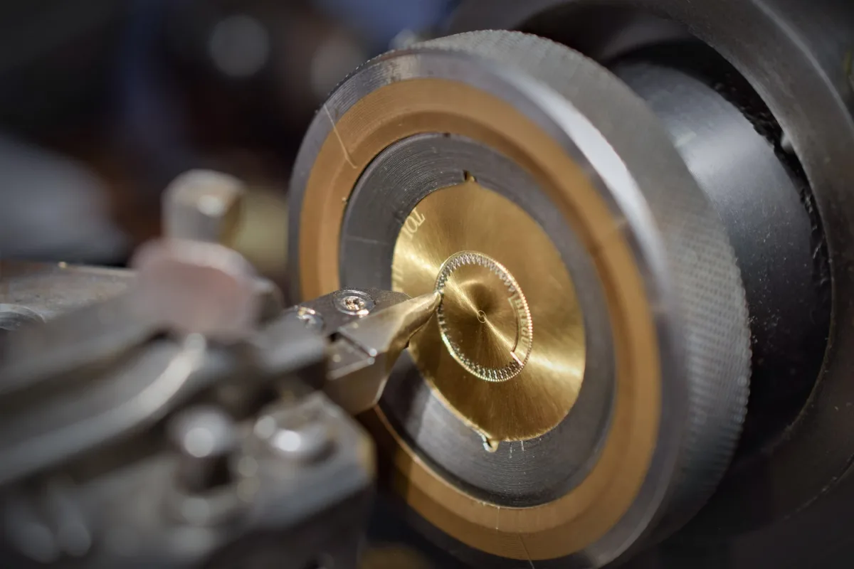 Craftsman at work on a guilloché dial