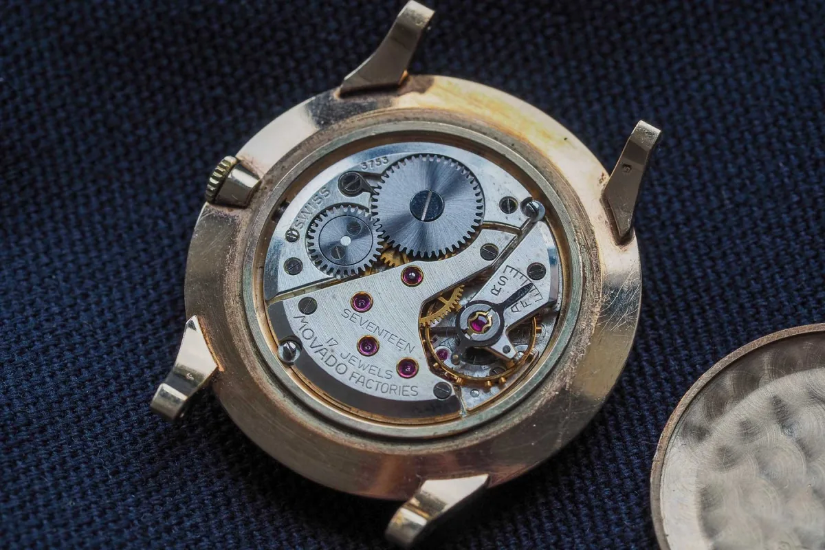 Silver dial of Movado Disco Volante with gold indices