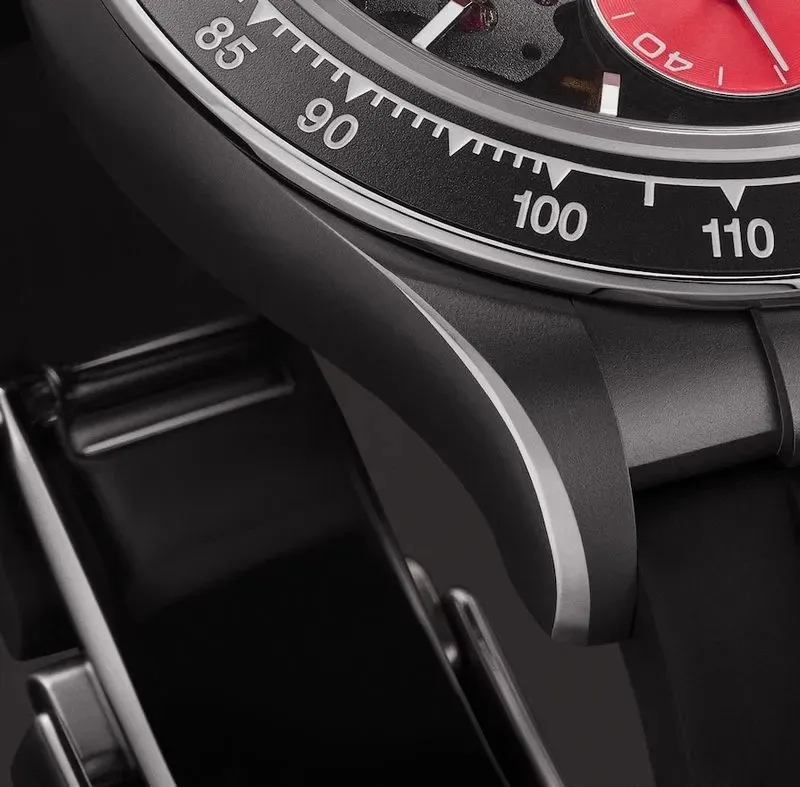 Skeletonized movement with tungsten rotor and orange-red letter 'A'