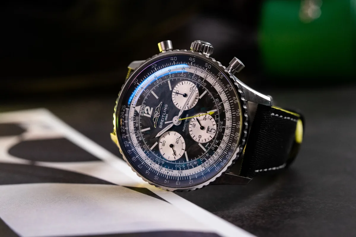 Breitling Navitimer watch close-up with carbon dial and green accents