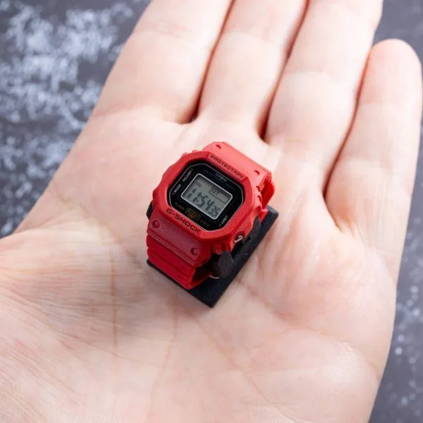 Casio G-Shock Nano DWN5600 worn on a doll's wrist