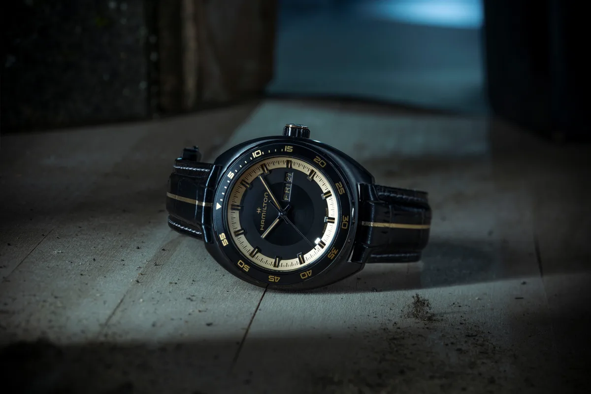 Two-toned crown and gold bezel text on Hamilton watch