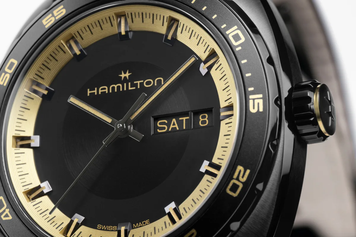 Matte black dial with gold accents on Hamilton Pan Europ