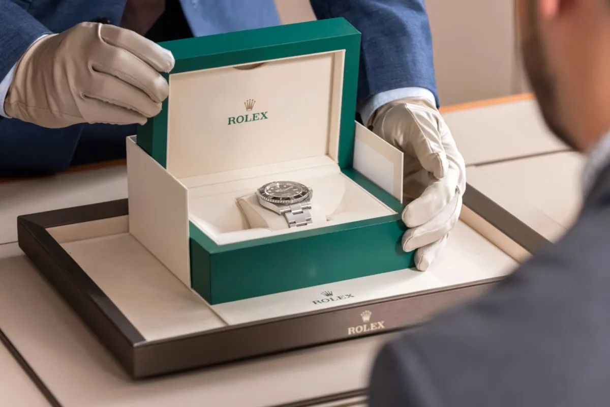 Watch collector examining a Rolex watch.