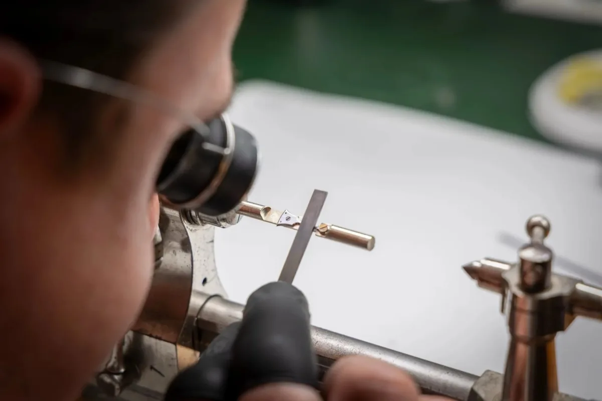 Young watchmaker working on a watch project