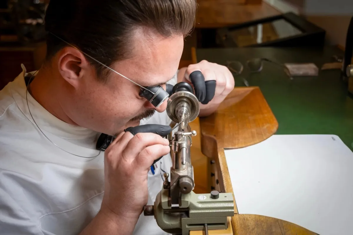 Jury members evaluating watchmaking skills