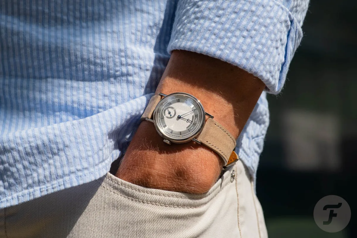 A wrist wearing the Breguet Classique 5907 in white gold.