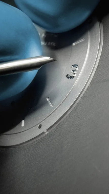 Engraved gold lettering on movement