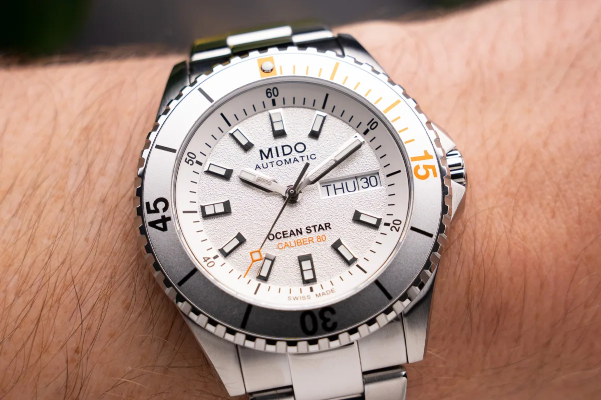 Textured dial of the Mido Ocean Star 200 with orange accents
