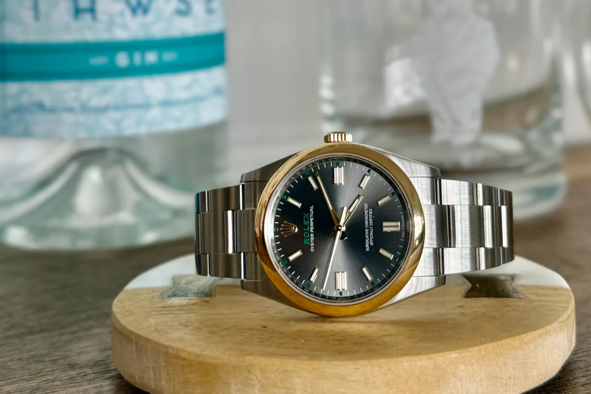 Anniversary markings on Rolex OP100 dial and crown
