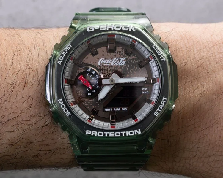 Casio G-Shock beside Coca-Cola collectibles