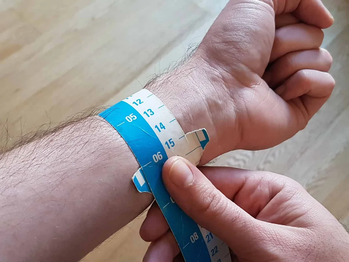 Wrist with a large watch case, appearing oversized
