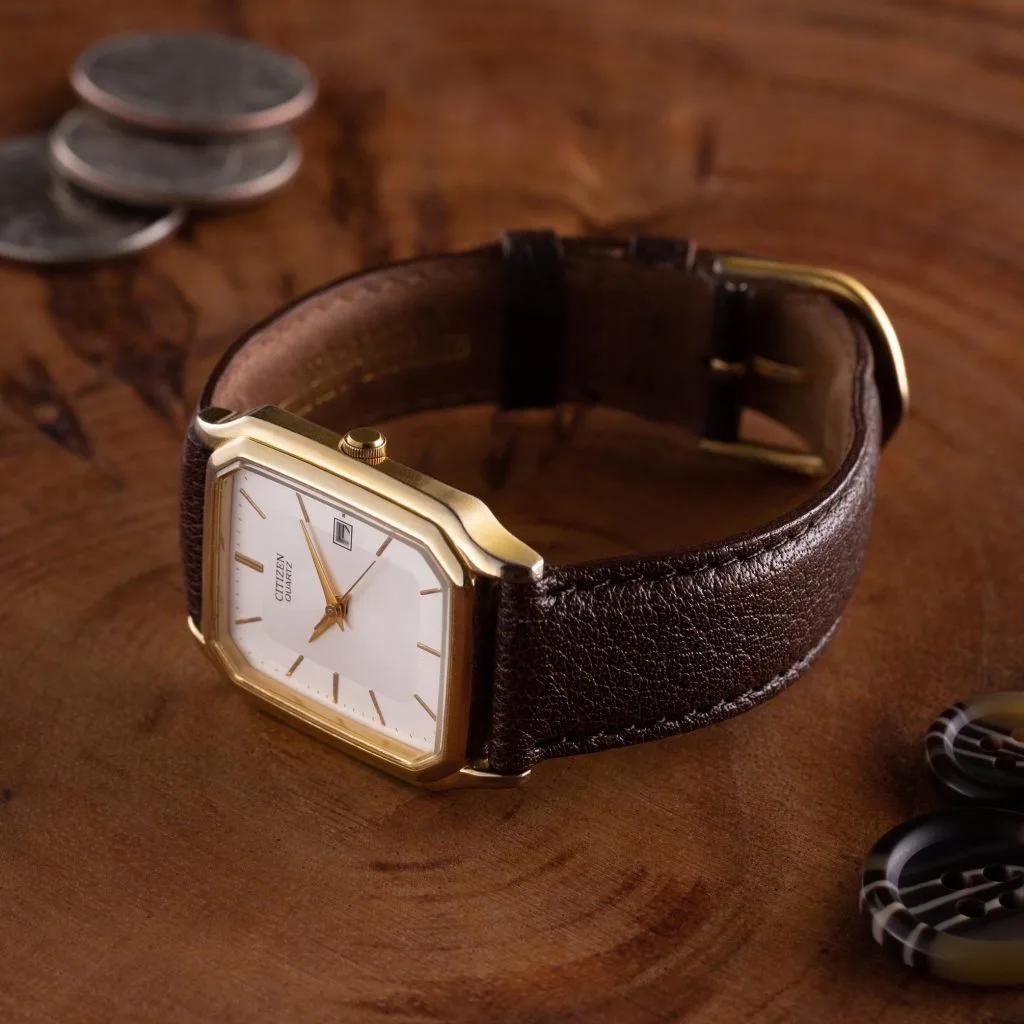 Classic watch illustration highlighting thin case and minimalist dial.